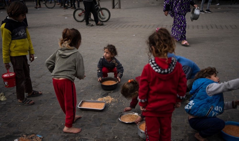 Palestinian kids receive free food in Rafah, Gaza Strip, Palestine, Friday, Feb. 23, 2024. (AP)
