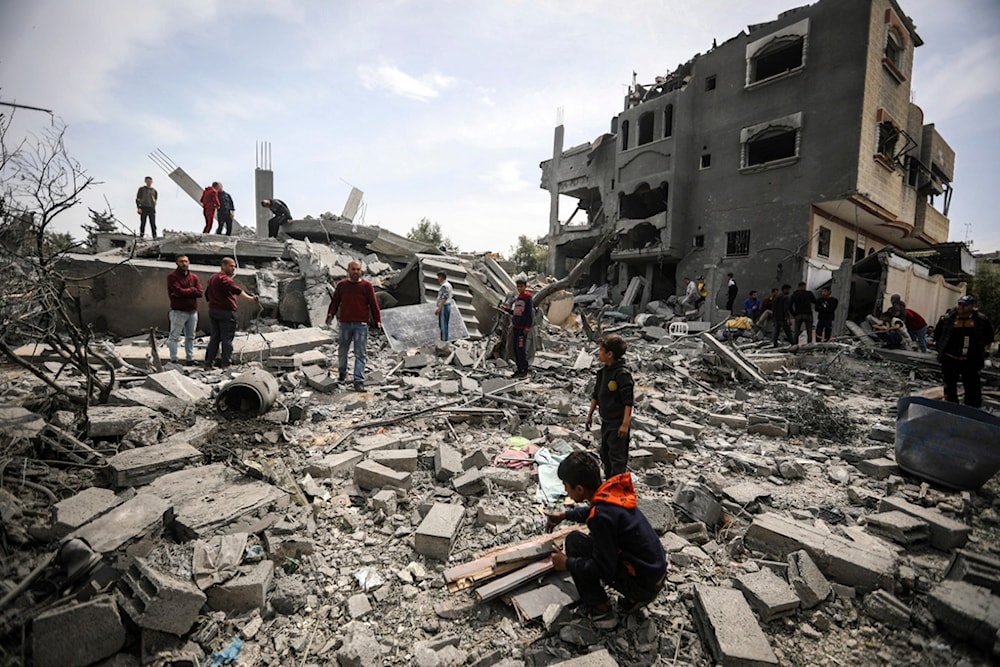 Palestinians inspect the damage to a residential building for the Moussa family after an Israeli airstrike in the Maghazi refugee camp, central Gaza Strip, Friday, March 29, 2024. (AP)