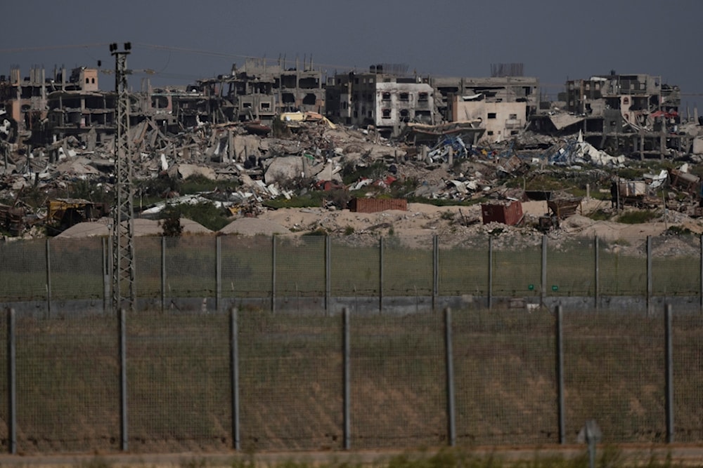 Destroyed buildings stand in the Gaza Strip as seen from southern Palestine, Thursday, March 28, 2024. (AP Photo/Leo Correa)
