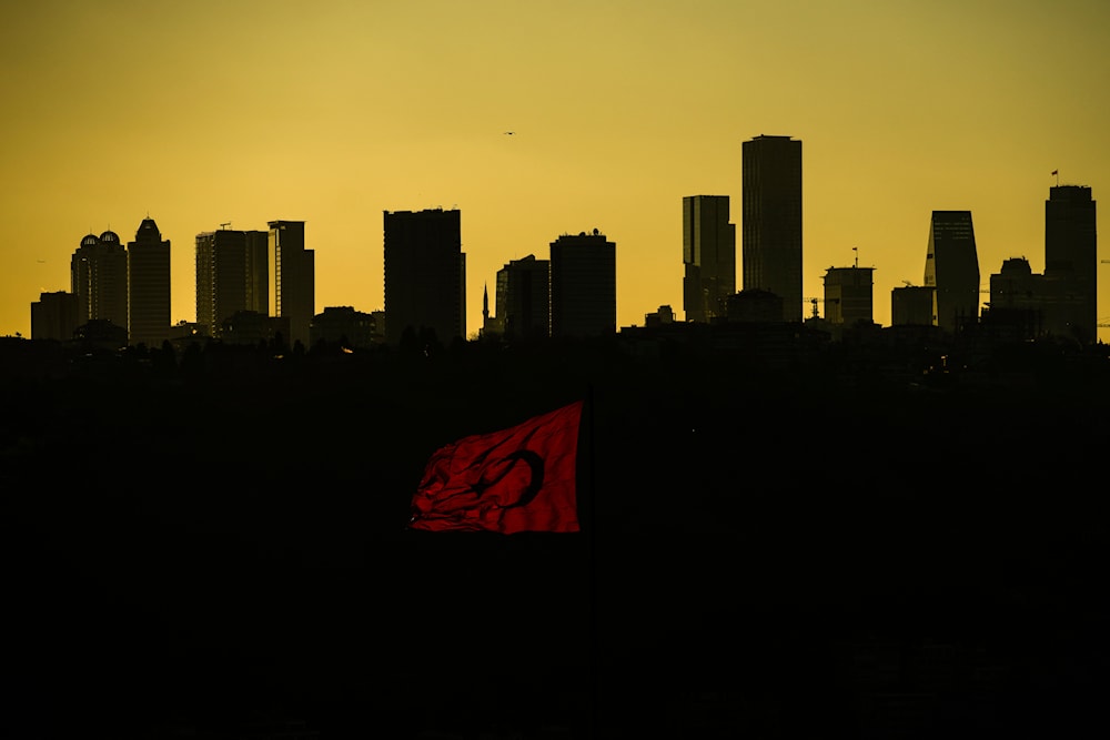 The sun sets behind high buildings of a financial business area in Istanbul, Turkey, Friday, March 22, 2024. (AP)