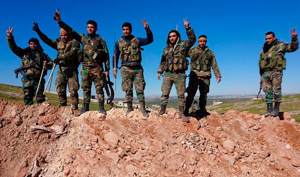 In this photo released by the Syrian official news agency SANA, Syrian army soldiers flash the victory sign in the village of al-Eis, in Aleppo province, Syria, Sunday, Feb. 9, 2020. (AP)