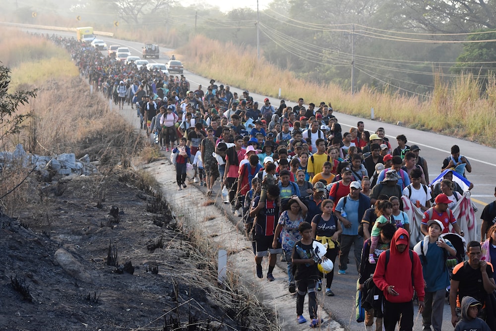 Migrants walk along the highway through Arriaga, Chiapas state in southern Mexico, January 8, 2024, during their journey north toward the US border (AP)