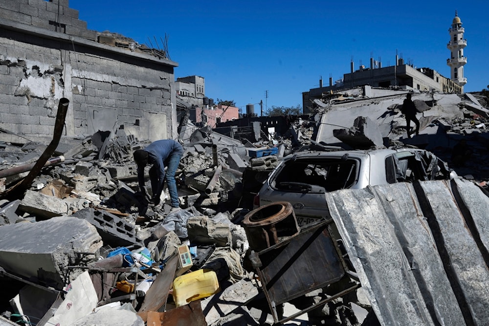 Palestinians inspect the rubble of destroyed buildings after an Israeli airstrike in Nusseirat refugee camp, central Gaza Strip, occupied Palestine, Feb. 29, 2024. (AP)