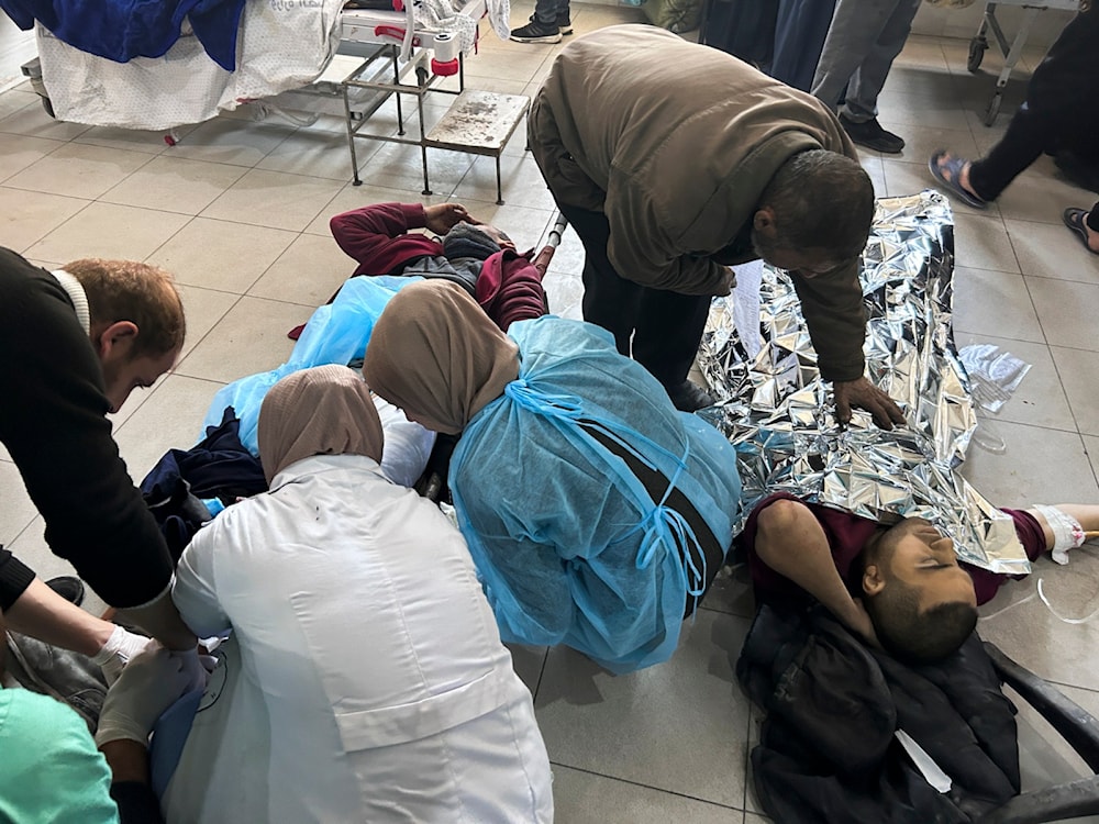 Palestinians wounded in an Israeli strike while waiting for humanitarian aid on the beach in Gaza City are treated in al-Shifa Hospital in Gaza City, February 29, 2024 (AP)