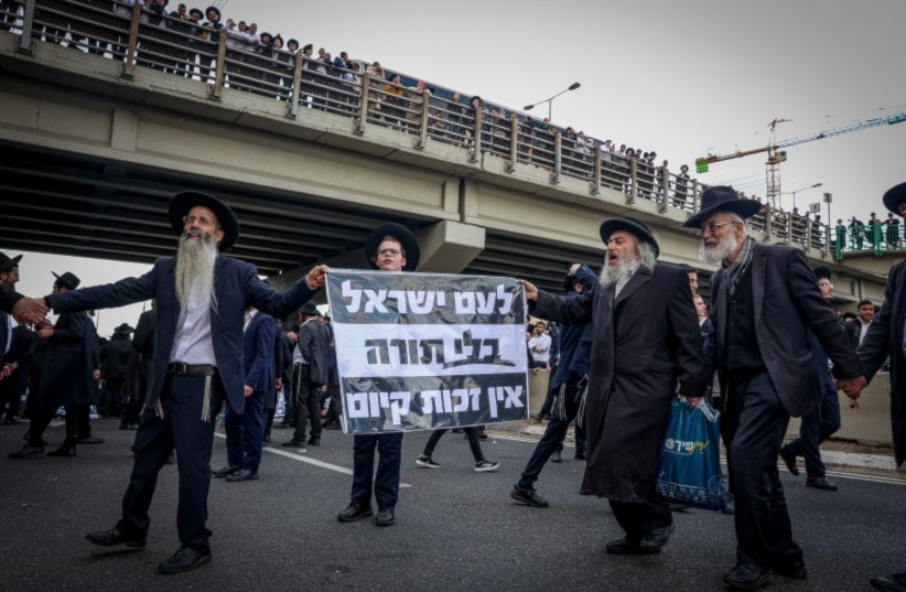 Ultra-Orthodox Haredi Jews block a road during a protest outside the settlement of 