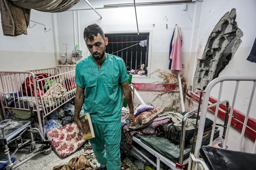 A Palestinian nurse inspects the damage in a room at Nasser Hospital in Khan Younis in the southern Gaza Strip on Dec. 17, 2023, following Israeli bombardment. (AFP via Getty Images)
