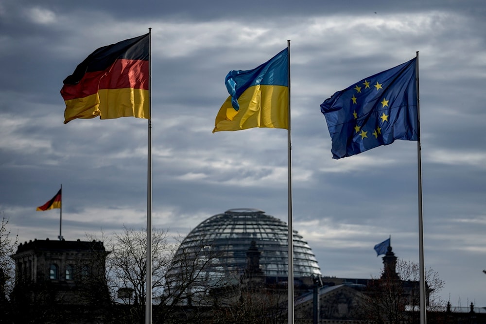 A German, Ukrainian and European flag wave in front of the Reichstag building in Berlin, Germany, Friday, Feb.16, 2024. (AP)
