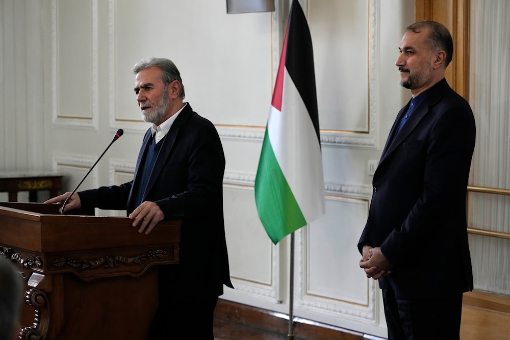 The leader of the Palestinian Islamic Jihad, Ziyad al-Nakhaleh, briefs the media after his meeting with the Iranian Foreign Minister Hossein Amir-Abdollahian, right, in Tehran, Iran, Saturday, March 30, 2024 (AP)