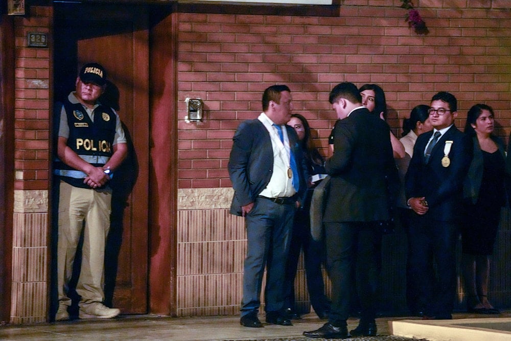 Police and prosecutors stand outside President Dina Boluarte's house during a raid in Lima, Peru, Saturday, March 30, 2024. (AP)