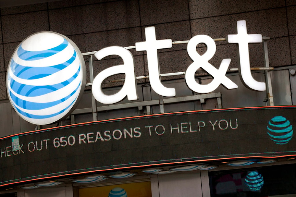  In this Monday, Oct. 24, 2016, file photo, the AT&T logo is positioned above one of its retail stores, in New York. (AP)