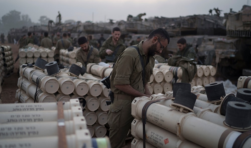 Israeli soldiers from the artillery unit store tank shells in a staging area at the Gaza border in southern occupied Palestine, Monday, Jan. 1, 2024 (AP)