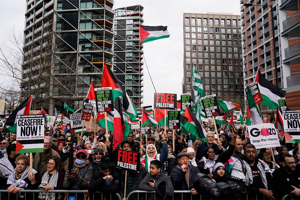 Demonstrators hold flags and placards as they attend a march in support of the Palestinian people in Gaza, in London, Saturday, March 9, 2024.(AP)