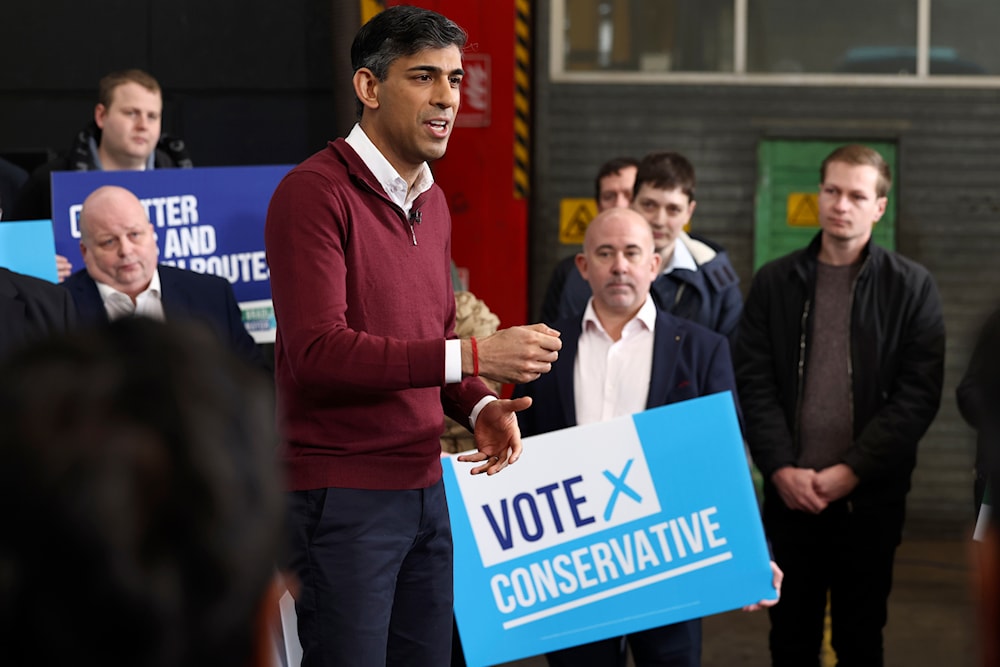 Britain's Prime Minister Rishi Sunak speaks to employees of a bus depot during the launch of the local elections campaign in Heanor, England, Friday, March 22, 2024. (AP)
