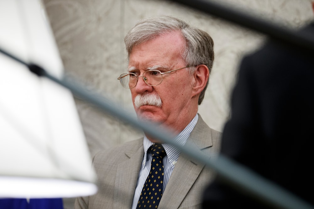 National security adviser John Bolton listens as President Donald Trump speaks during a meeting with Romanian President Klaus Iohannis in the Oval Office of the White House, on August 20, 2019, in Washington. (AP)