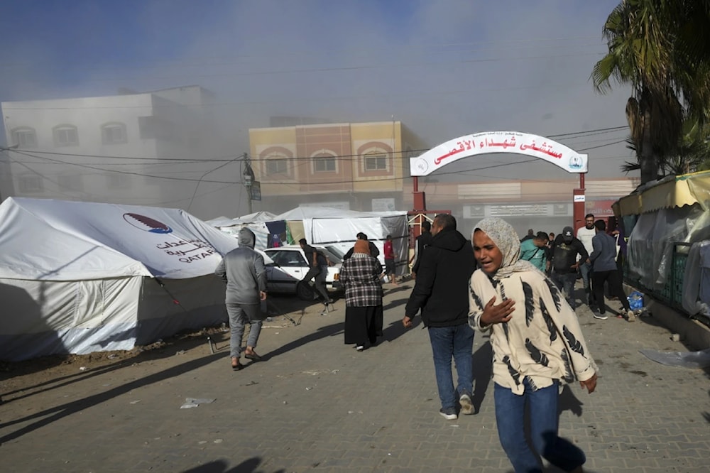 Palestinians run after an Israeli strike hit the vicinity of al-aqsa Hospital on January 10, 2023. (AP)