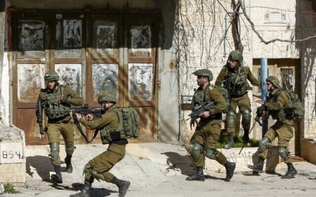 Illustrative: Israeli occupation soldiers shooting at Palestinians, in Bethlehem on February 6, 2020. (AFP)