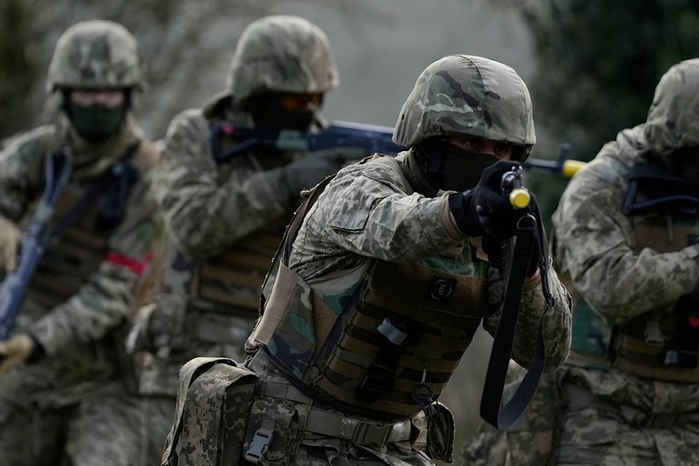 Ukrainian recruits under the guidance of British soldiers train at an army camp in South West England, Tuesday, Feb. 20, 2024. The recruits were being instructed on urban warfare. (AP)