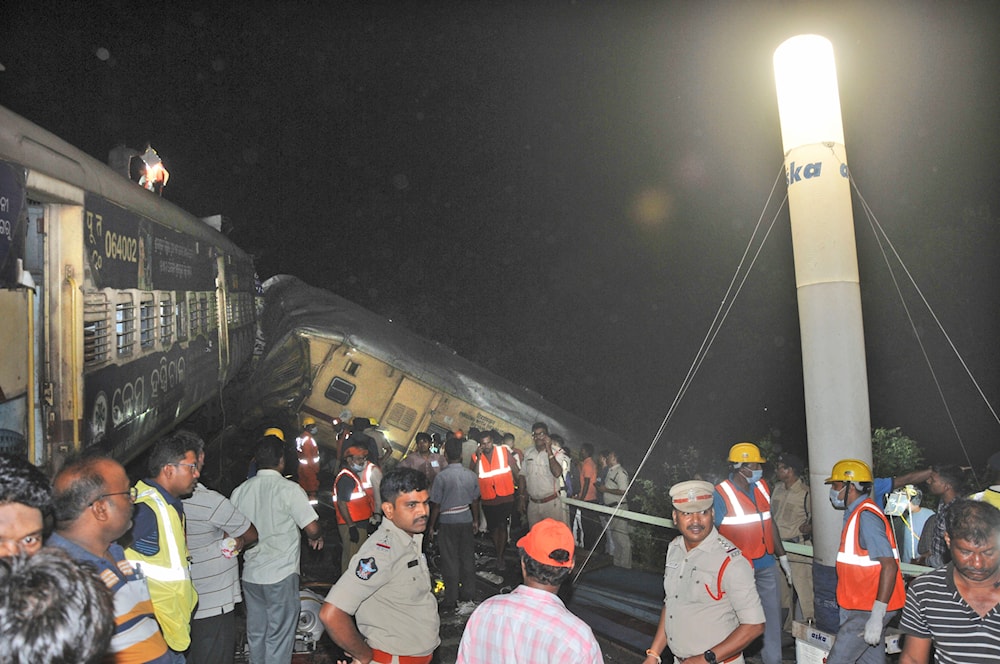 Rescuers and others stand after two passenger trains collided in Vizianagaram district, Andhra Pradesh state, India, Sunday, Oct.29, 2023.(AP)