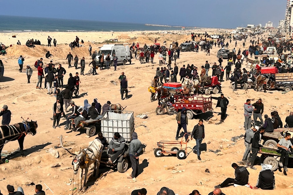 Palestinians wait for humanitarian aid on a beachfront in Gaza City, Gaza Strip, Sunday, Feb. 25, 2024 (AP Photo/Mahmoud Essa)