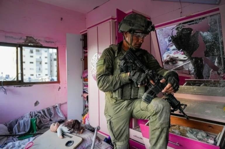 An Israeli occupation soldier vandalizes a Palestinian home during current genocide in Gaza. (AFP)