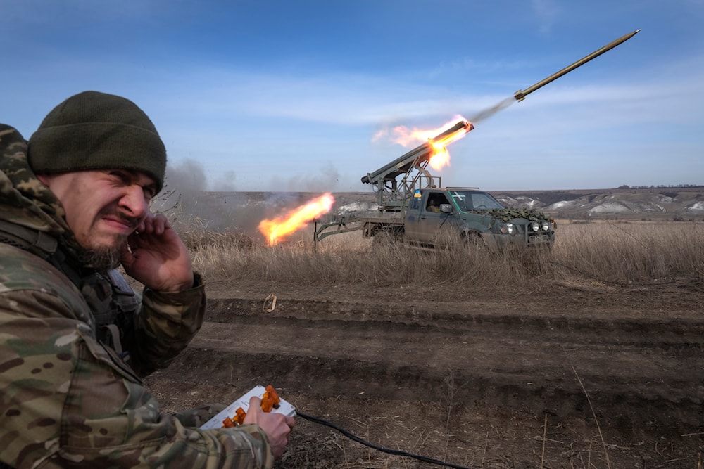 A Ukrainian officer from The 56th Separate Motorized Infantry Mariupol Brigade fires a multiple-launch rocket system based on a pickup truck near Bakhmut, Donetsk, Ukraine, March 5, 2024 (AP)