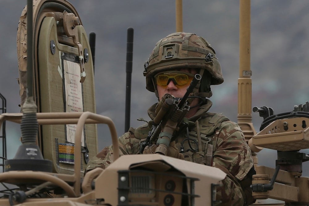 A British soldier with NATO-led Resolute Support Mission forces arrives at the site of an attack in Kabul, Afghanistan, Wednesday, March 25, 2020 (AP)