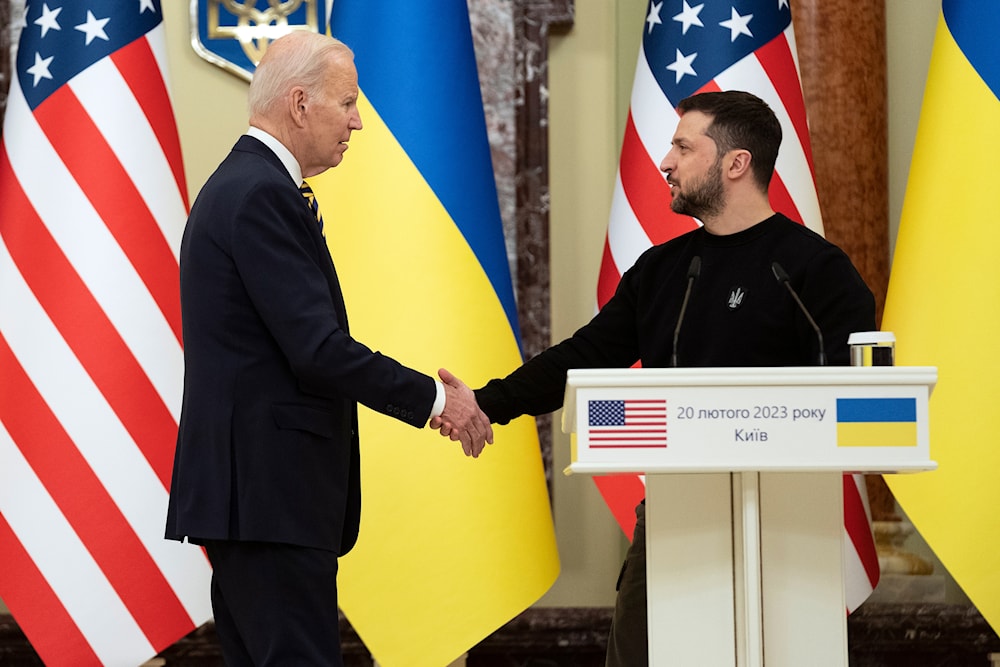 US President Joe Biden, left, shakes hands with Ukrainian President Volodymyr Zelenskyy after they both delivered statements at Mariinsky Palace during an unannounced visit, in Kyiv, Ukraine, Monday, Feb. 20, 2023.(AP)