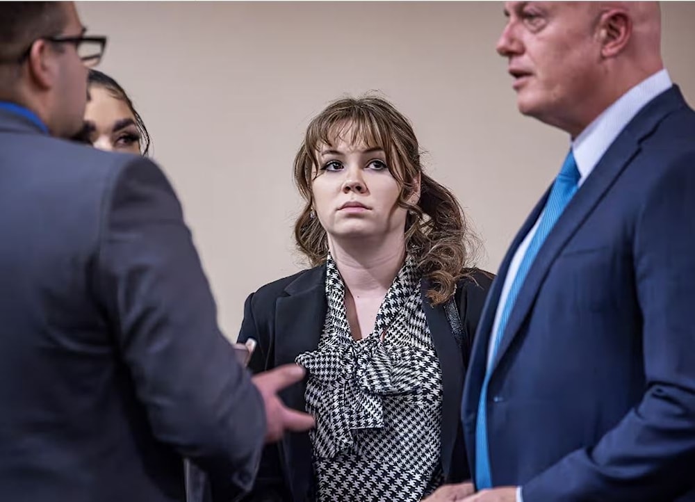 Hannah Gutierrez-Reed, center, talks with her attorney and defense team during the trial. (Jim Weber/AP)