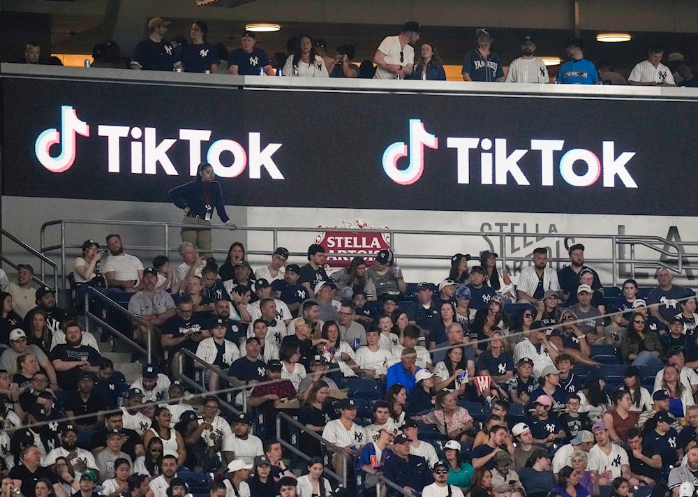 Fans sit under a TikTok ad at a baseball game at Yankee Stadium, April 14, 2023, in New York. (AP)