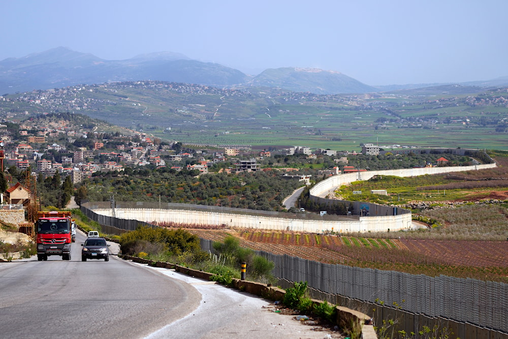 Cars drive in the village of Kfar Kila, on the Lebanese-Israeli border in southeast Lebanon, Friday, April 7, 2023. (AP)