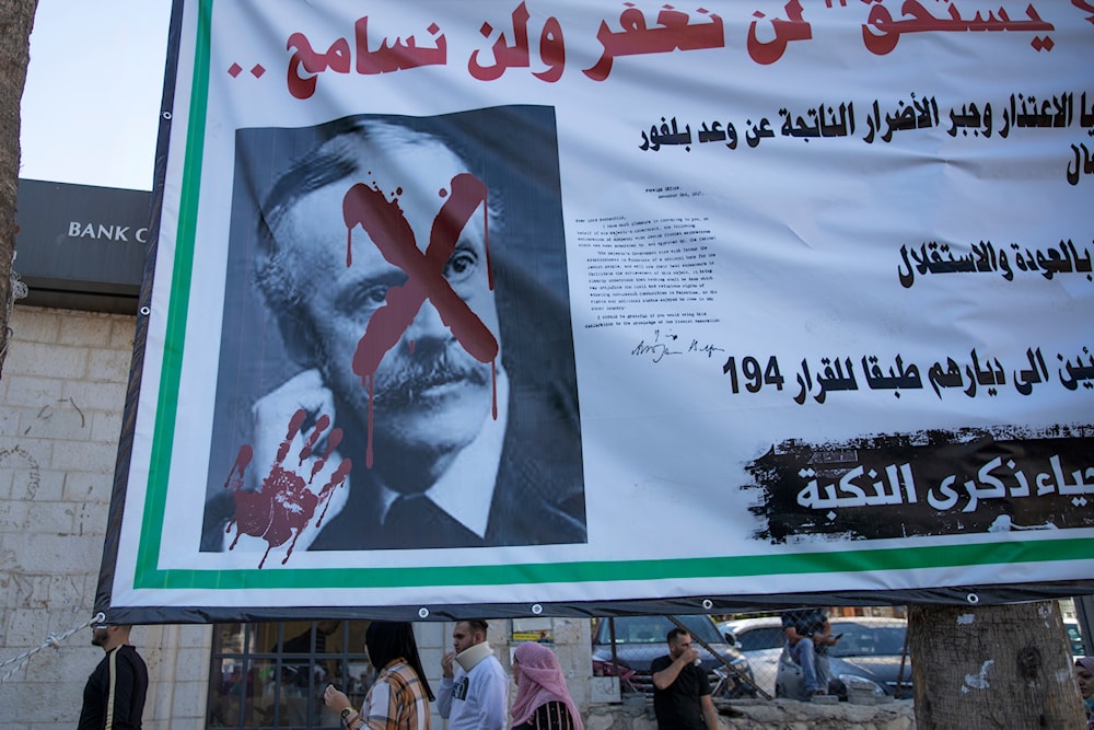 A Billboard with a defaced picture of British Foreign Secretary Arthur Balfour reading, 'we will not forget, we will not forgive,' in the street in Ramallah, occupied Palestine Nov. 4, 2021 (AP)