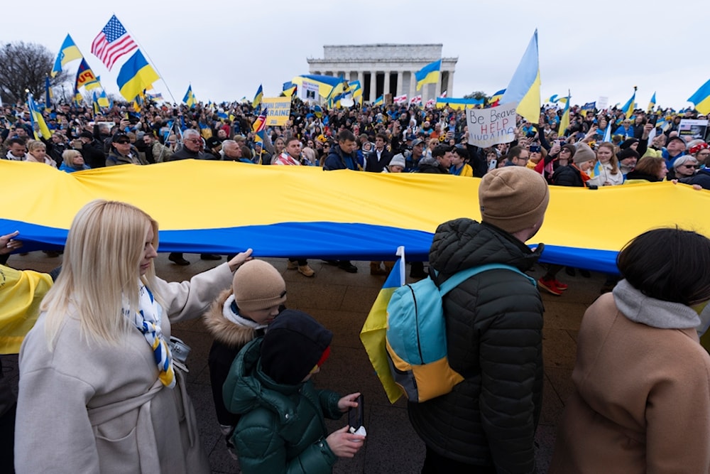 Ukrainians and their supporters carry a huge Ukrainian flag during a rally at the National Mall near the Lincoln Memorial in Washington, Saturday, Feb. 24, 2024. (AP)