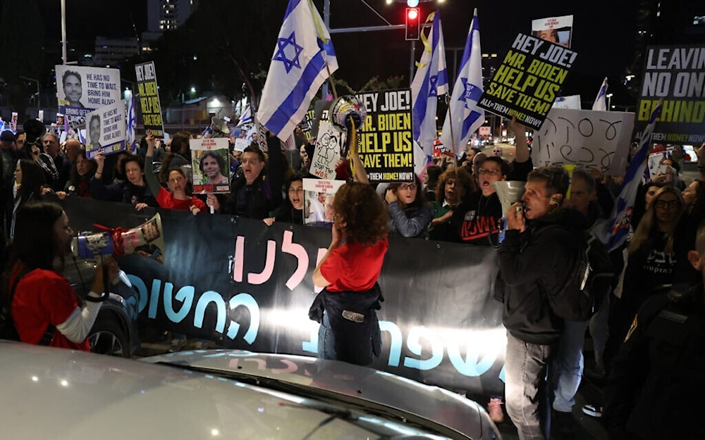 Israeli settlers block a road in 'Tel Aviv' on March 9, 2024. (AFP)