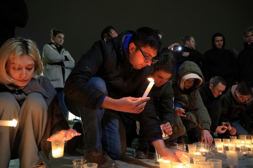 People light candles in memory of the victims of the terrorist attack in Moscow in Crimea, Friday March 22, 2024. (AP)