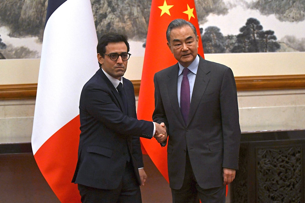 France's Minister for Foreign and European Affairs Stephane Sejourne,with China's Foreign Minister Wang Yi during a meeting in Beijing, China Monday, April 1, 2024. (AP/Pool)