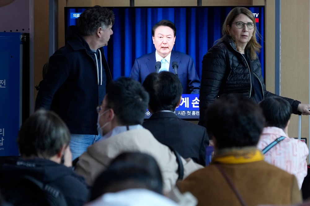 People watch a TV screen showing the live broadcast of South Korean President Yoon Suk Yeol’s addressing the nation at the Seoul Railway Station in Seoul, South Korea, Monday, April 1, 2024. (AP)
