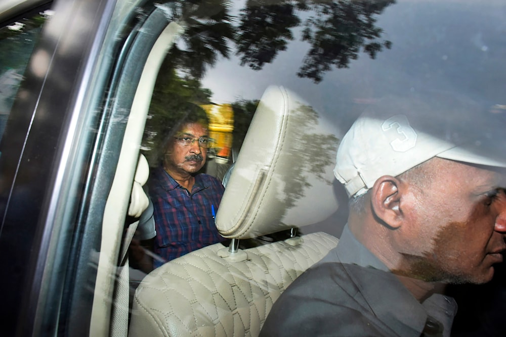 Arvind Kejriwal, leader of the Aam Admi Party, or Common Man's Party, left, leaves in a car after attending a hearing at a court, in New Delhi, India, Thursday, March 28, 2024. (AP)