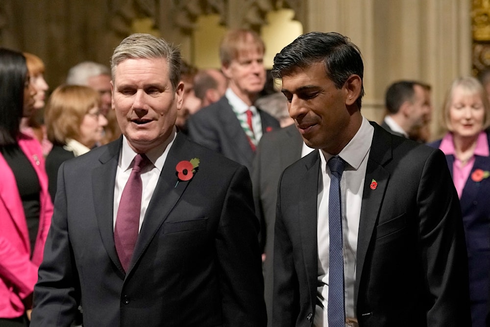 Britain's Prime Minister Rishi Sunak, right, and Labour Party leader Keir Starmer pass through the Peer's Lobby to attend the State Opening of Parliament at the Palace of Westminster in London, Tuesday, Nov. 7, 2023 (AP)