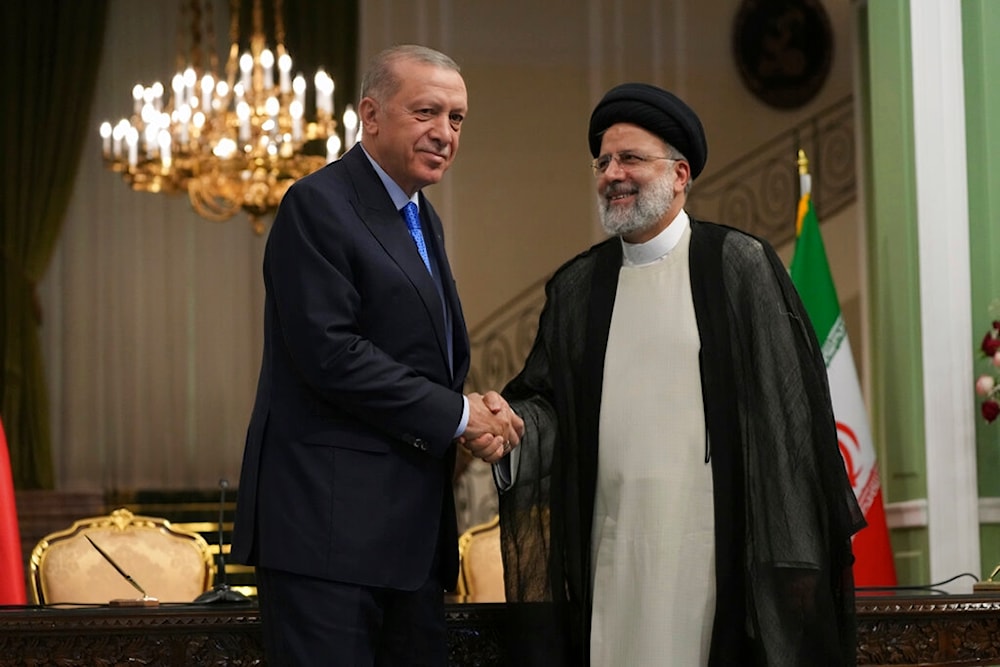 Turkish President Recep Tayyip Erdogan, left, and his Iranian counterpart Ebrahim Raisi shake hands at the conclusion of their joint press briefing at the Saadabad Palace, in Tehran, Iran, Tuesday, July 19, 2022 (AP Photo/Vahid Salemi)