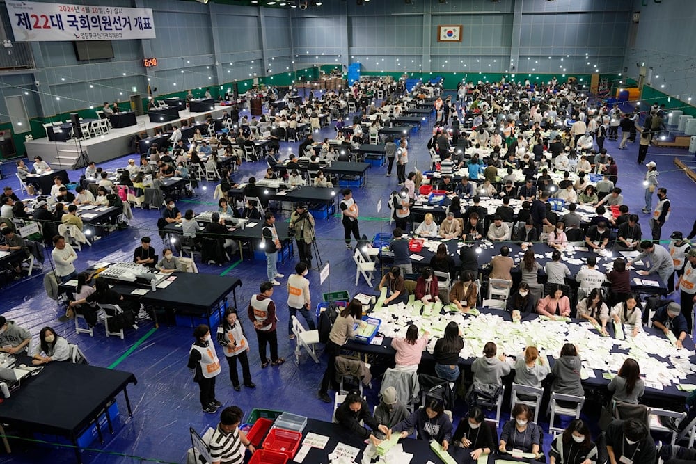 National Election Commission officials sort out ballots for counting at the parliamentary election in Seoul, South Korea, on Wednesday, April 10, 2024.(AP)