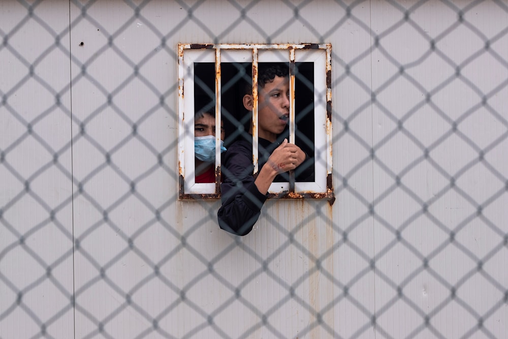  Children who crossed into Spain are seen inside a temporary shelter for unaccompanied minors in the enclave of Ceuta, next to the border of Morocco and Spain, May 20, 2021. (AP)