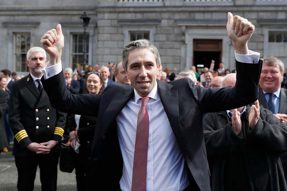 The new Prime Minister of Ireland, Simon Harris gestures as he is applauded by fellow lawmakers outside Leinster House, in Dublin, Ireland, Tuesday, April 9, 2024.(AP)