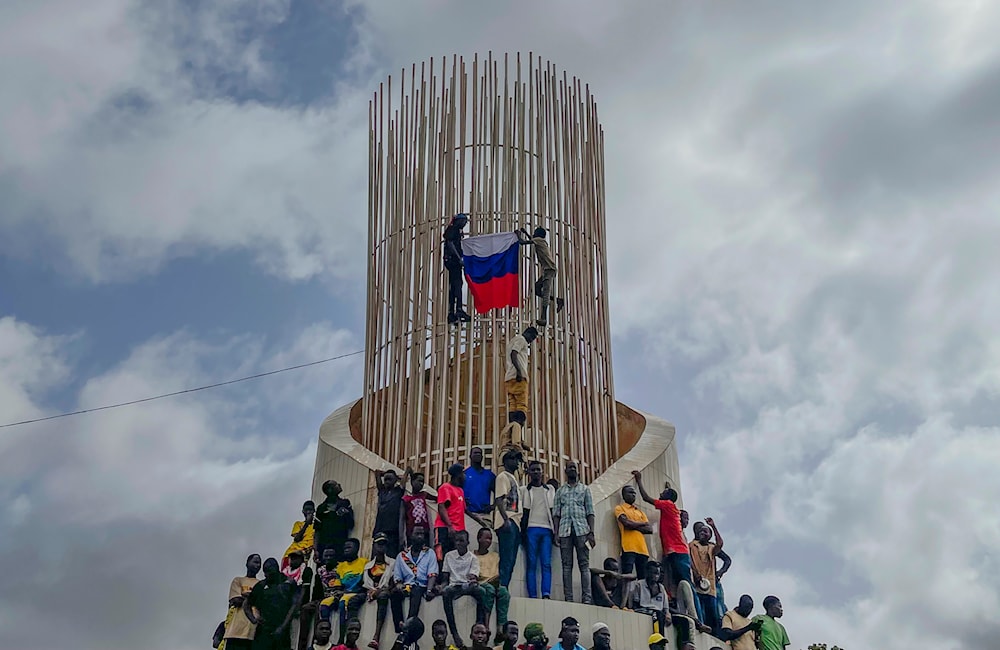 Supporters of Niger's ruling junta hold a Russian flag at the start of a protest in Niamey, Niger, on Aug. 3, 2023. (AP)