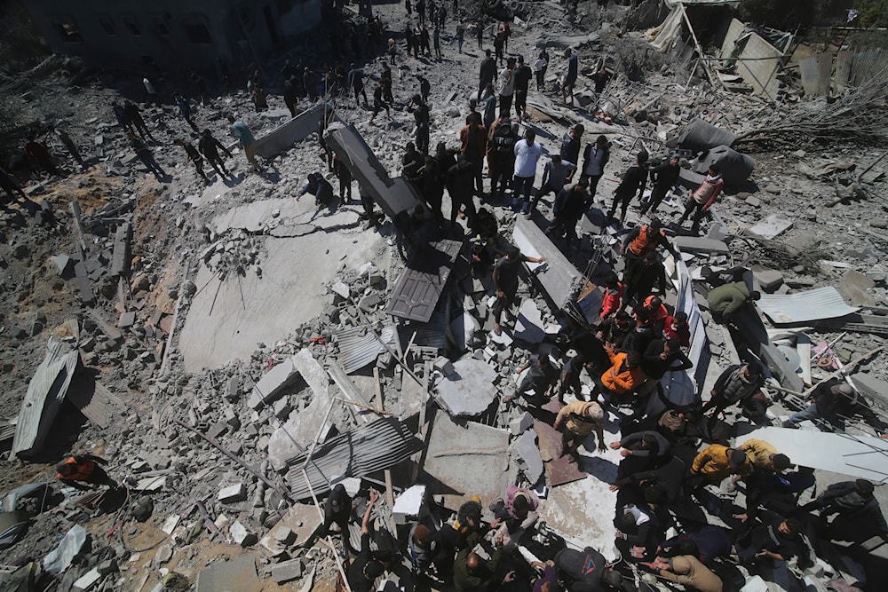 Palestinians look at a residential building destroyed in an Israeli strike in Rafah, Gaza Strip, Tuesday, March 20, 2024. (AP)