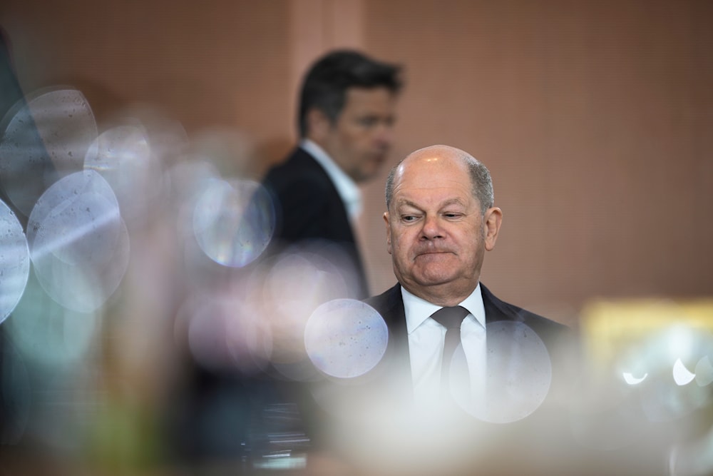 German Economy and Climate Minister Robert Habeck walks behind German Chancellor Olaf Scholz during the weekly cabinet meeting at the chancellery in Berlin, Germany, Wednesday, April 10, 2024. (AP)
