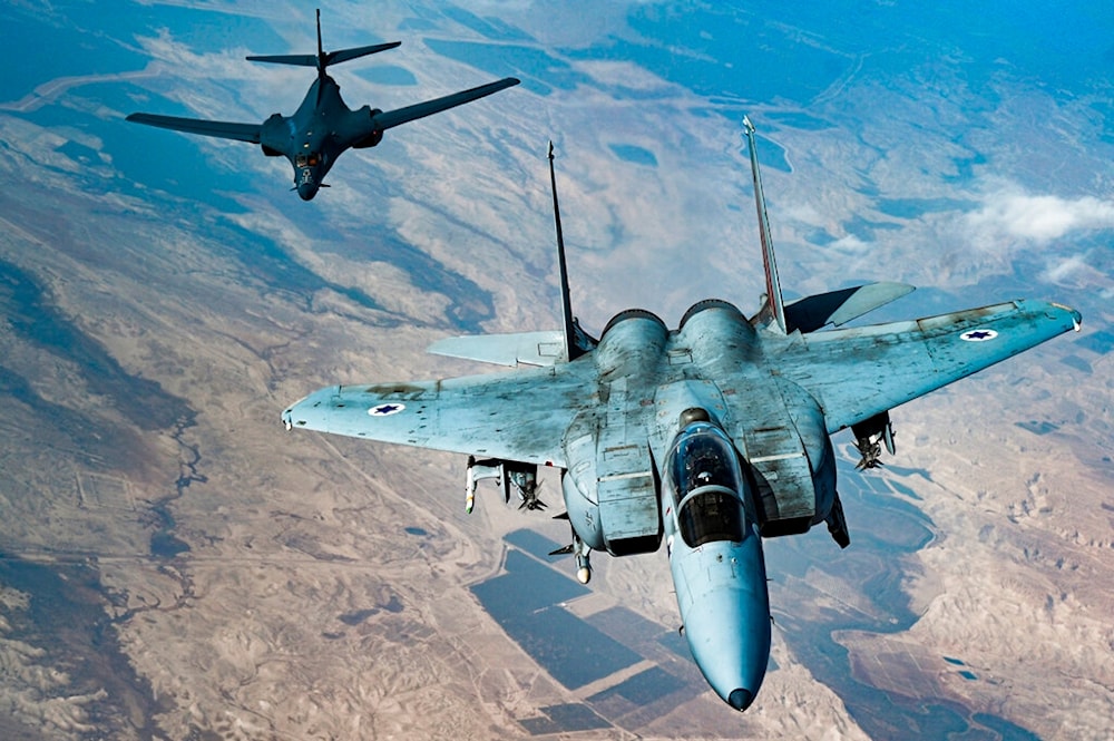 In this photo released by the U.S. Air Force, an Israeli Air Force F-15 Strike Eagle flies in formation with a U.S. Air Force B-1B Lancer over Israel as part of a deterrence flight Oct. 30, 2021. 