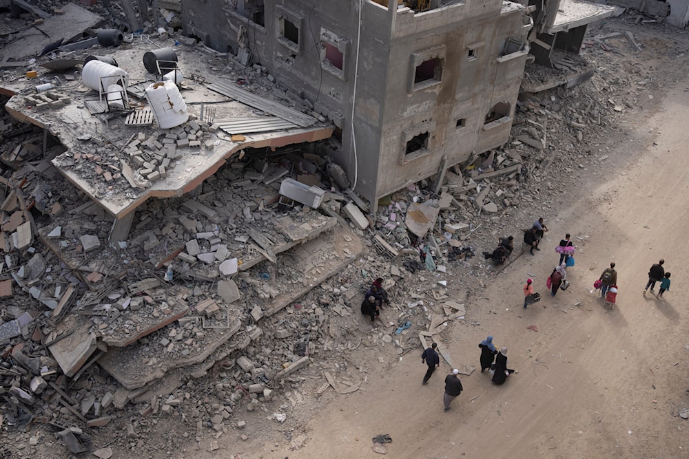 Palestinians walk through the destruction in the wake of an Israeli air and ground offensive in Khan Younis, southern Gaza Strip, Monday, April 8, 2024. (AP)