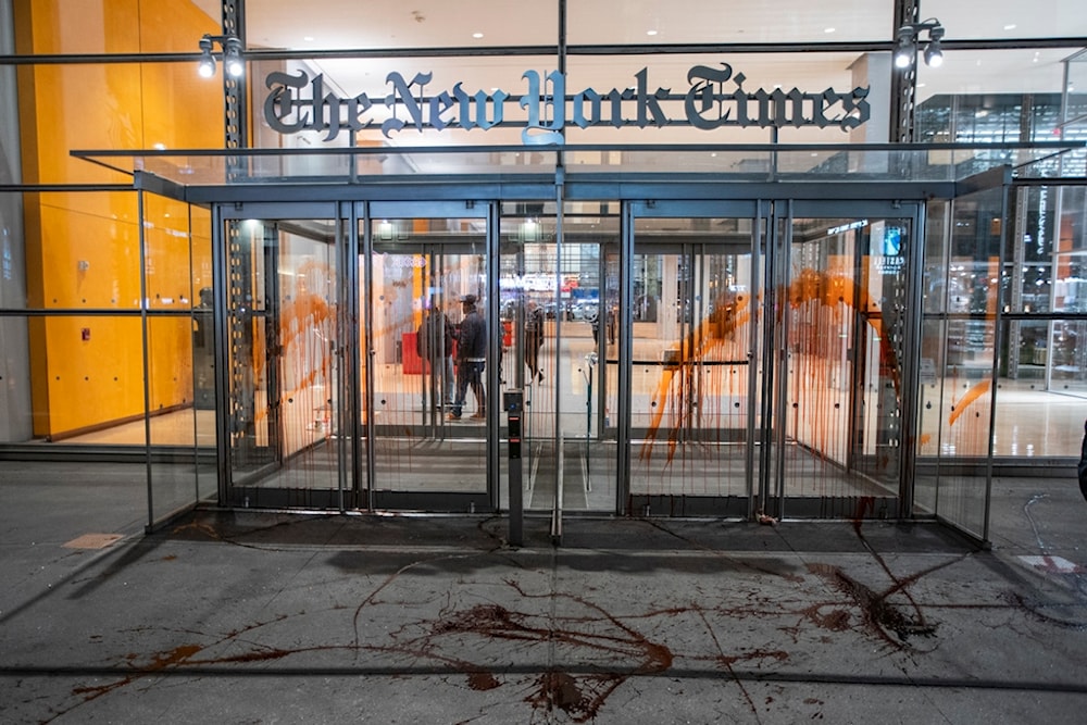 Photo shows The New York Times building entrance after being vandalized with red tint by Pro-Palestinian demonstrators as they march calling for a ceasefire in Gaza, Nov. 10, 2023, in New York. (AP)