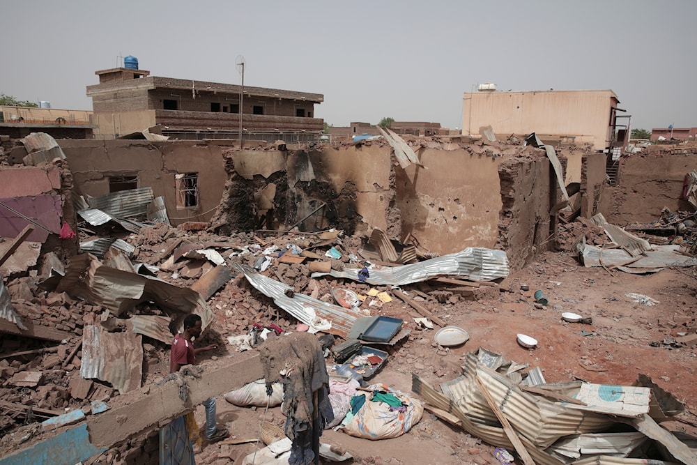 A man walks by a house hit in fighting in Khartoum, Sudan, Tuesday, April 25, 2023. (AP)