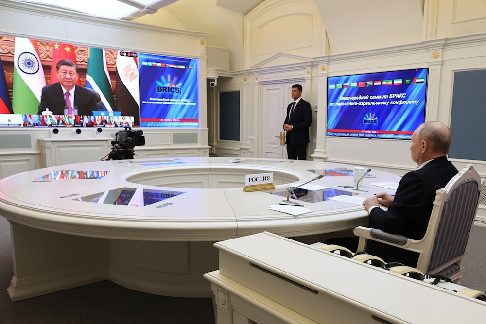 Russian President Vladimir Putin, right, takes part in an extraordinary BRICS summit via videoconference as China's President Xi Jinping is seen on the screen, at the Kremlin in Moscow, Russia, Tuesday, Nov. 21, 2023. (AP)
